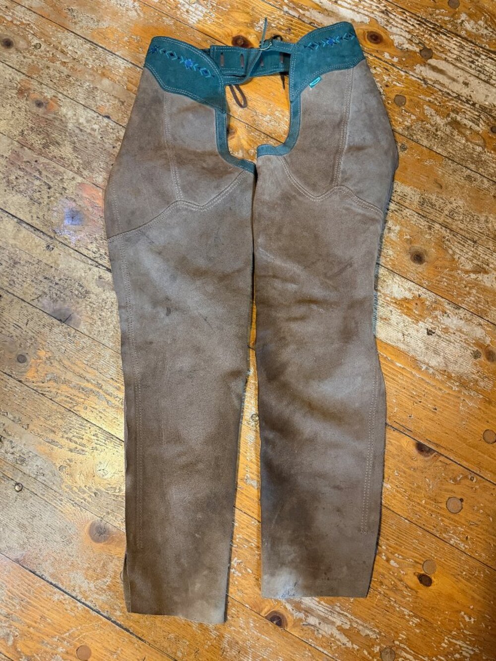 Brown leather suede chaps and set of spurs